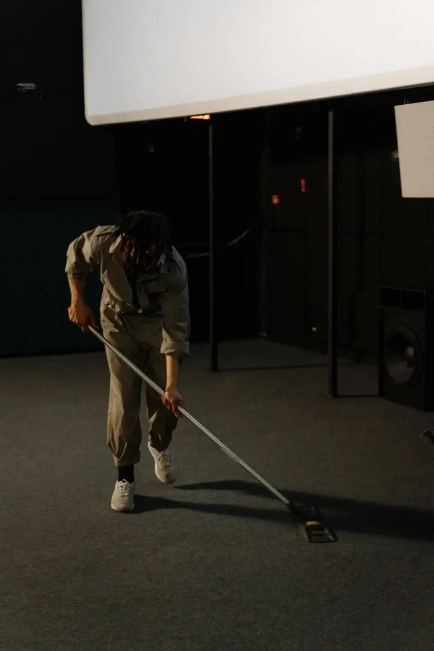 Technician cleaning commercial carpet in a theater